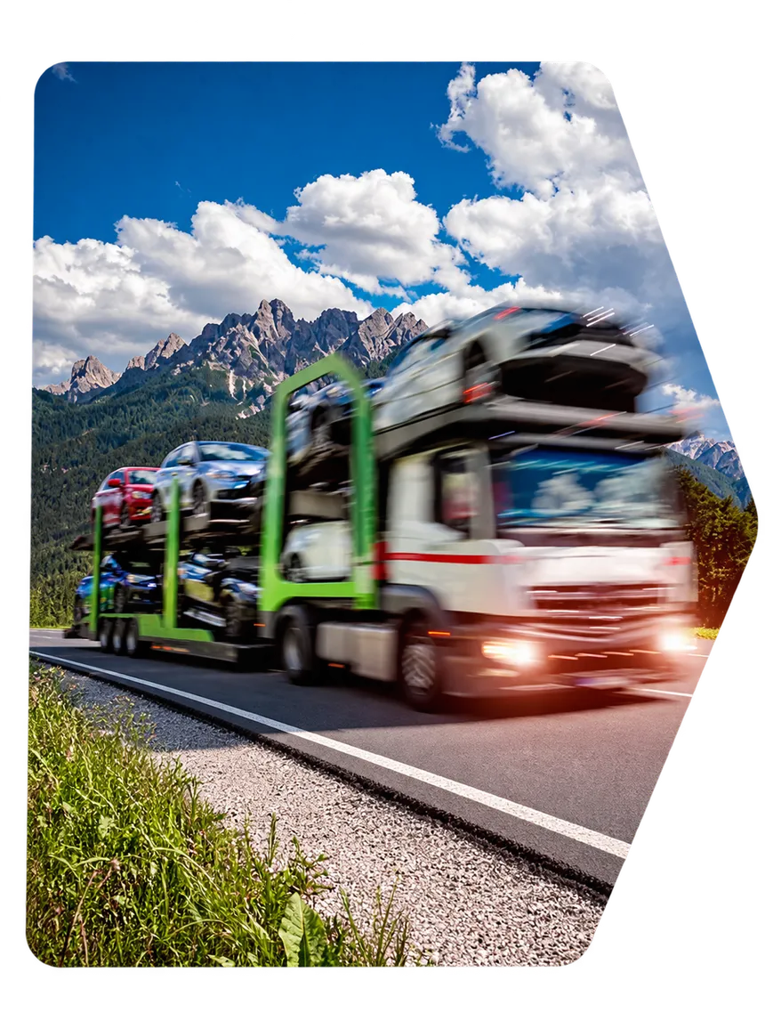 A multi-car carrier hauling vehicles along a mountain highway