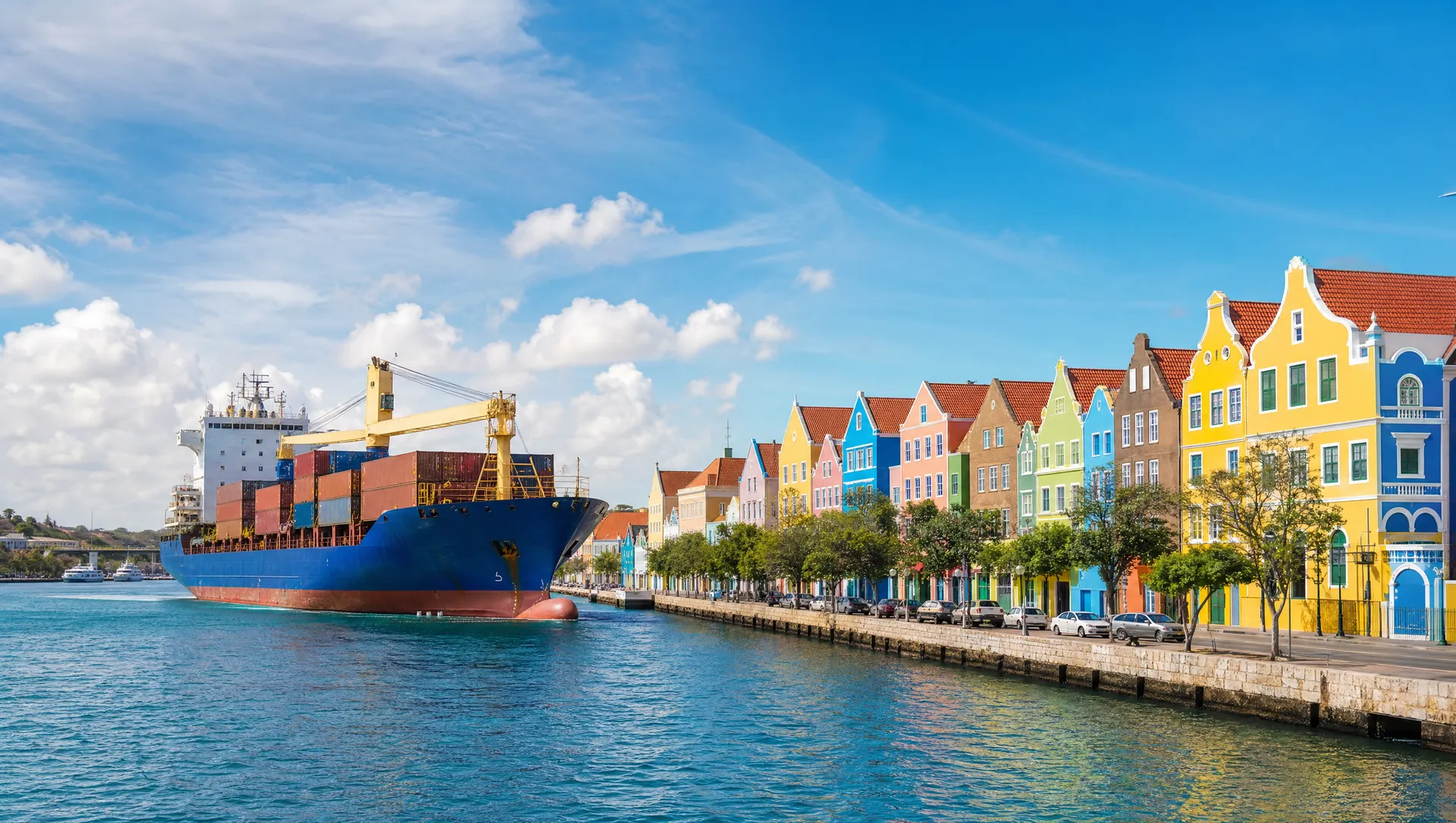 A cargo ship passing Willemstad's colorful waterfront in Curaçao